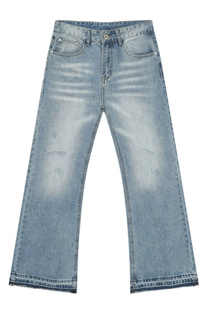Baggy distressed denim jeans in medium wash with raw hem detail and whiskering.