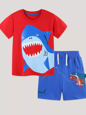 Red cotton t-shirt with shark graphic and blue shorts with shark detail.