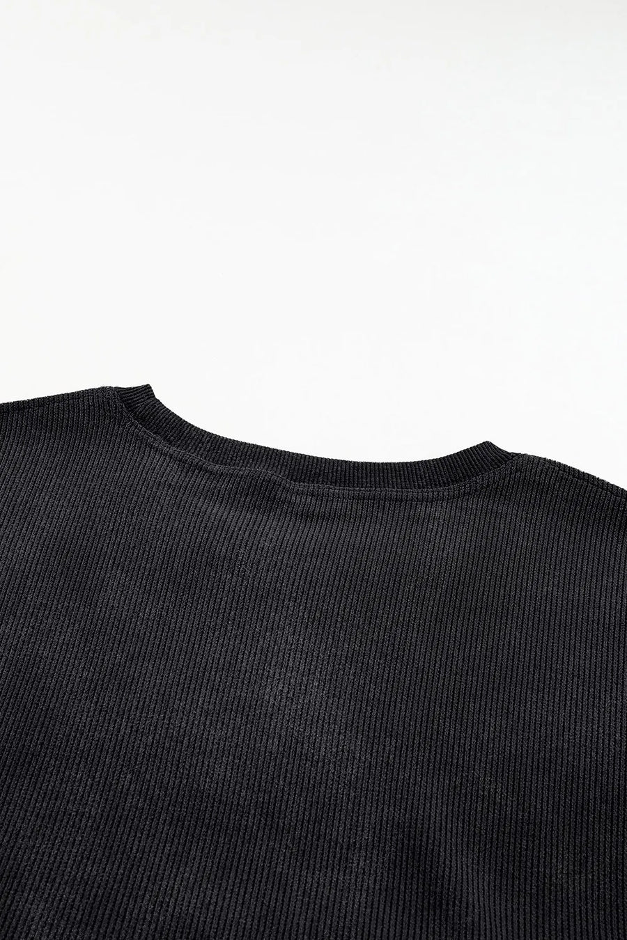 Black ribbed crewneck sweatshirt with a subtle heart outline detail.