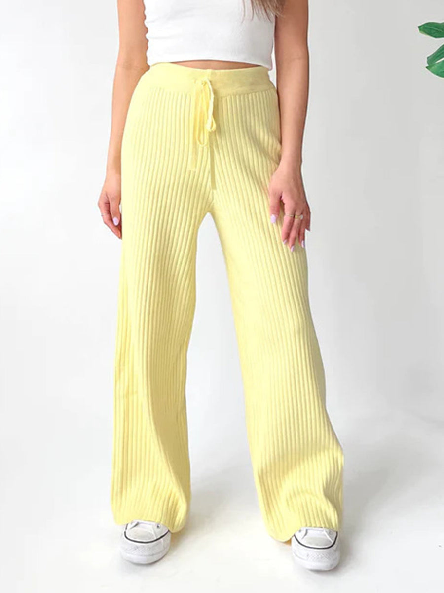 Luxe ribbed knit palazzo trousers in pastel yellow with drawstring waist.