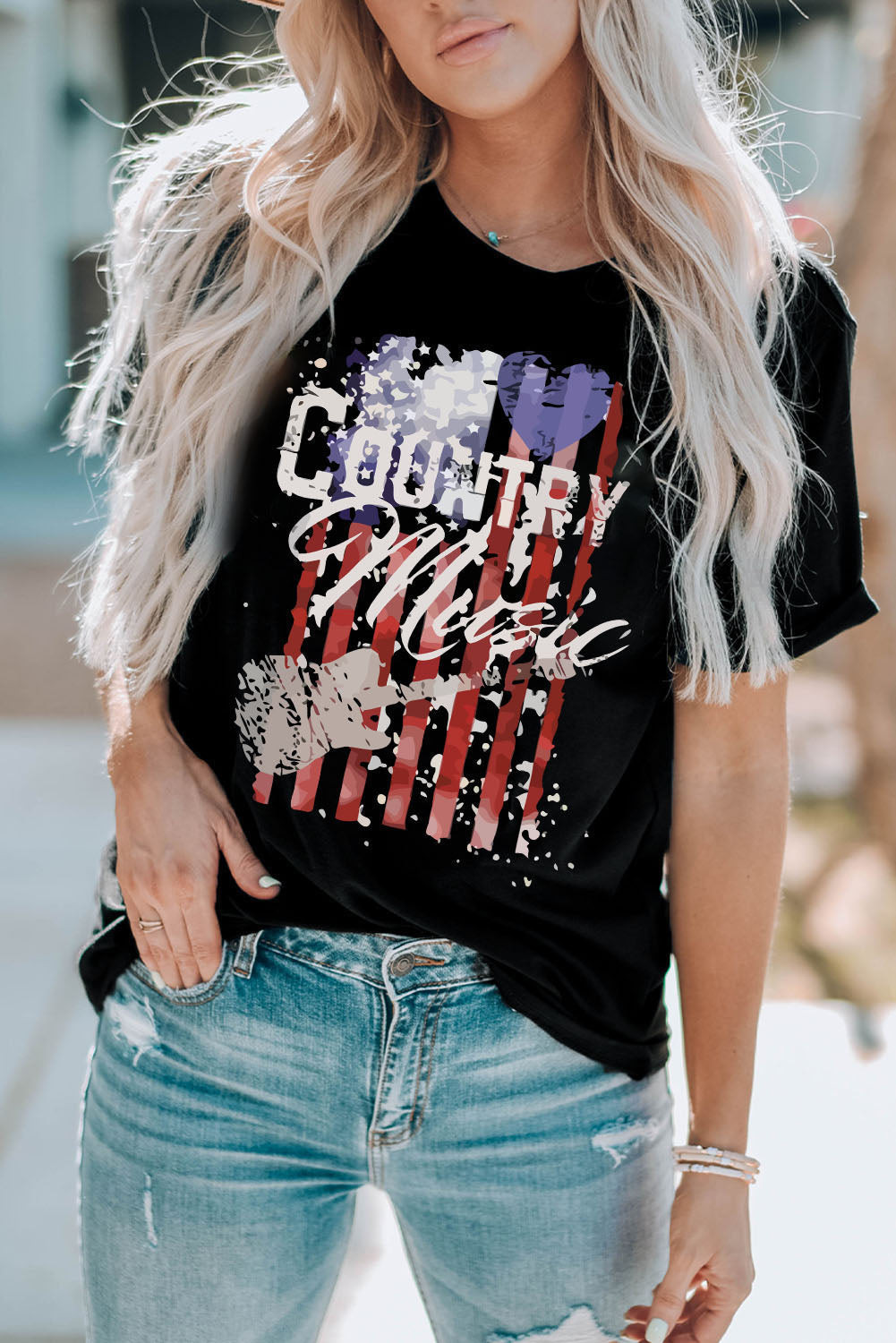 Black t-shirt with distressed American flag graphic and country music text.