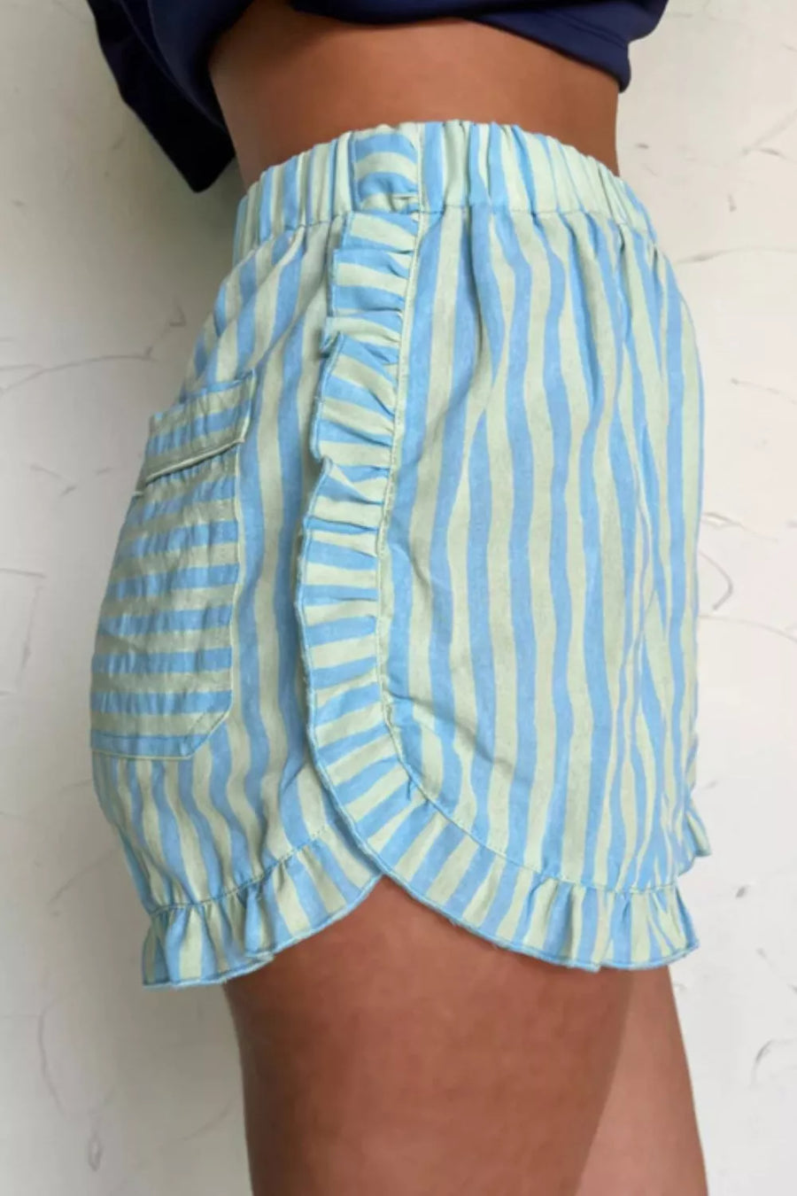Ruffled striped cotton shorts with a pocket and elastic waist.