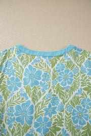 Floral ruffled half sleeve maternity blouse with blue flowers and green leaves pattern.
