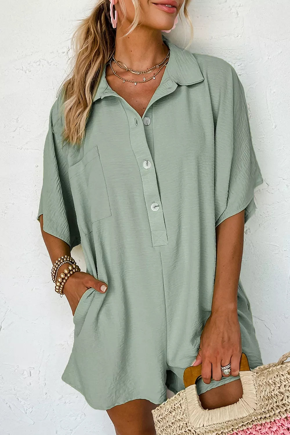 Sage green collared button-down romper with half sleeves and chest pocket