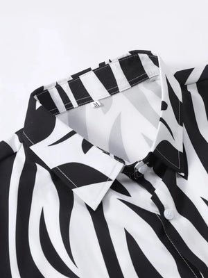 Black and white zebra print button-down shirt with a collared neckline.