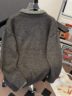 Gray ribbed hem long-sleeve sweater with a collared neckline.