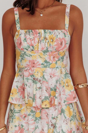 Peplum top with floral print, square neckline, and ruffled tiers.