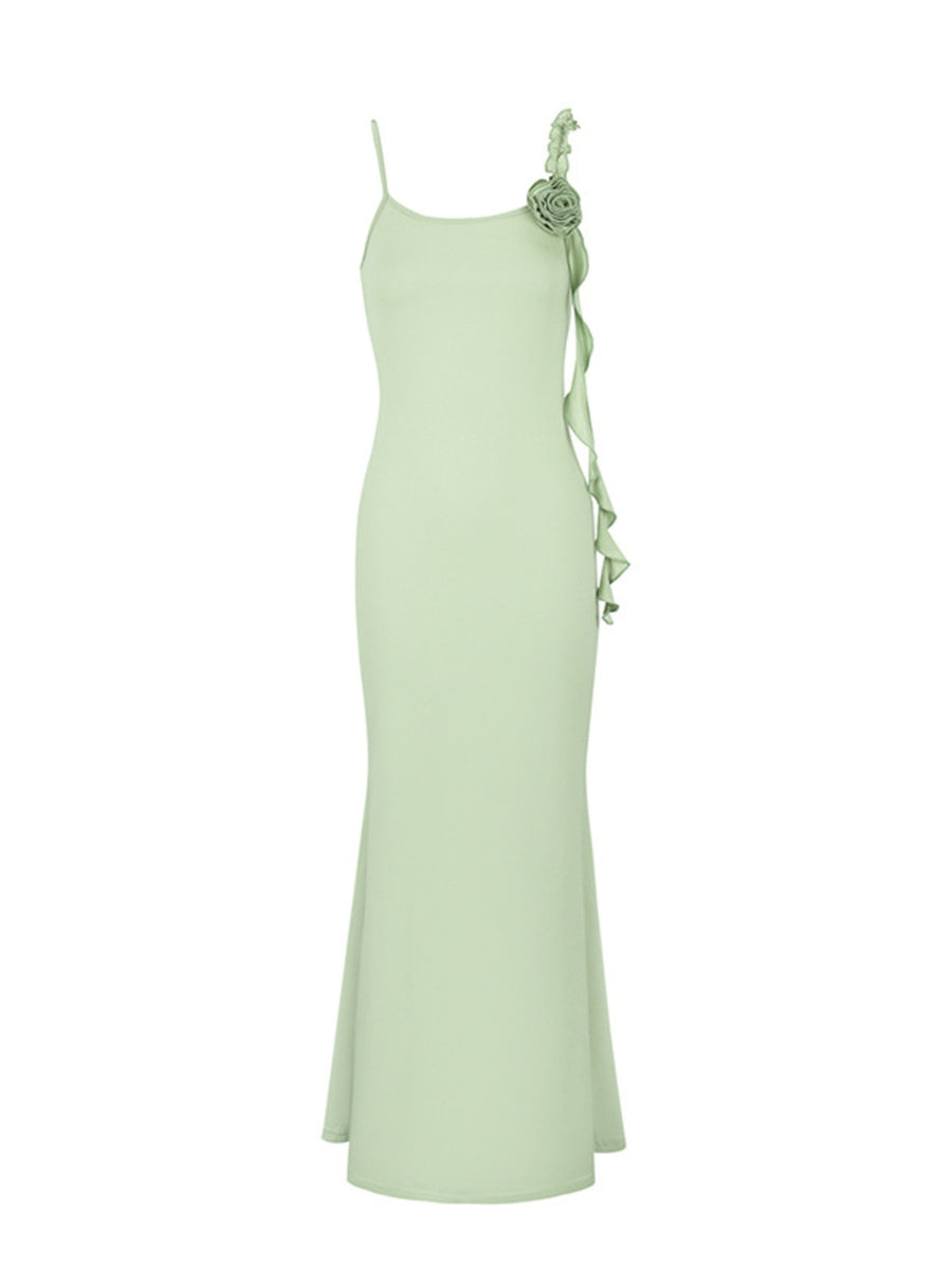 Light green ruffled mermaid maxi dress with spaghetti straps and a floral detail.