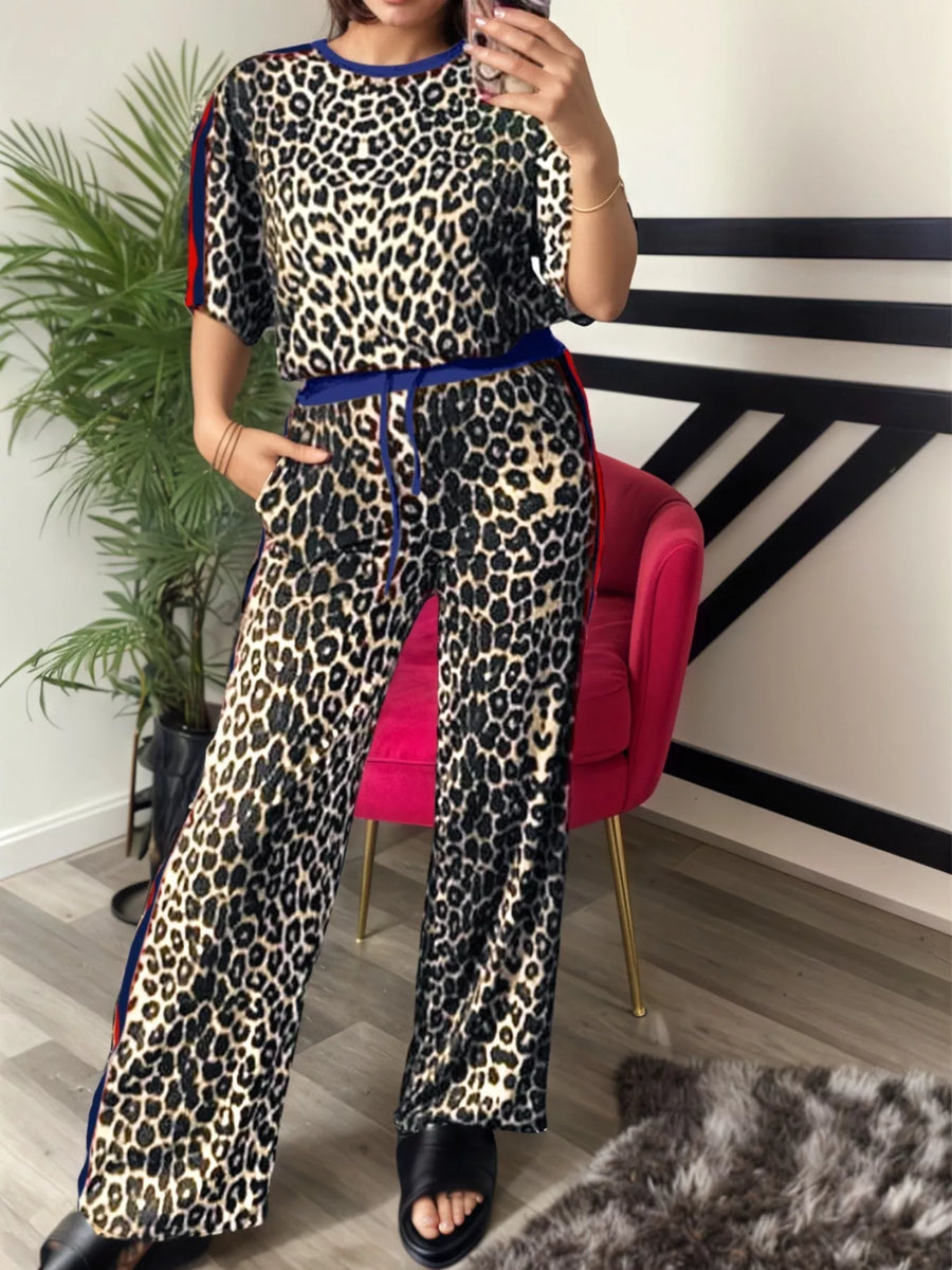 Leopard print loungewear set with blue trim on top and pants, featuring a crew neck and drawstring waist.
