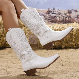 White embroidered western-inspired mid-calf boots with block heels and pointed toe.