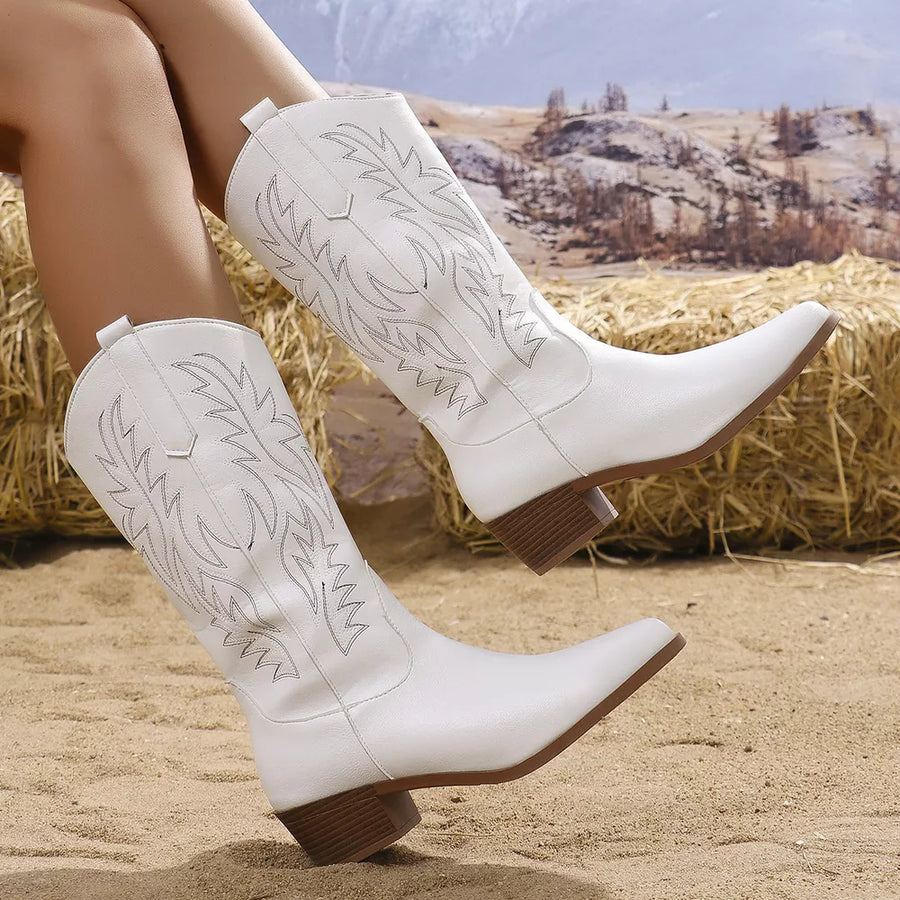 White embroidered western-inspired mid-calf boots with block heels and pointed toe.