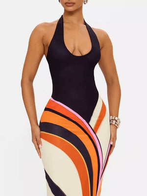 Black halter neck maxi dress with a bold abstract stripe print in orange, pink, and navy.