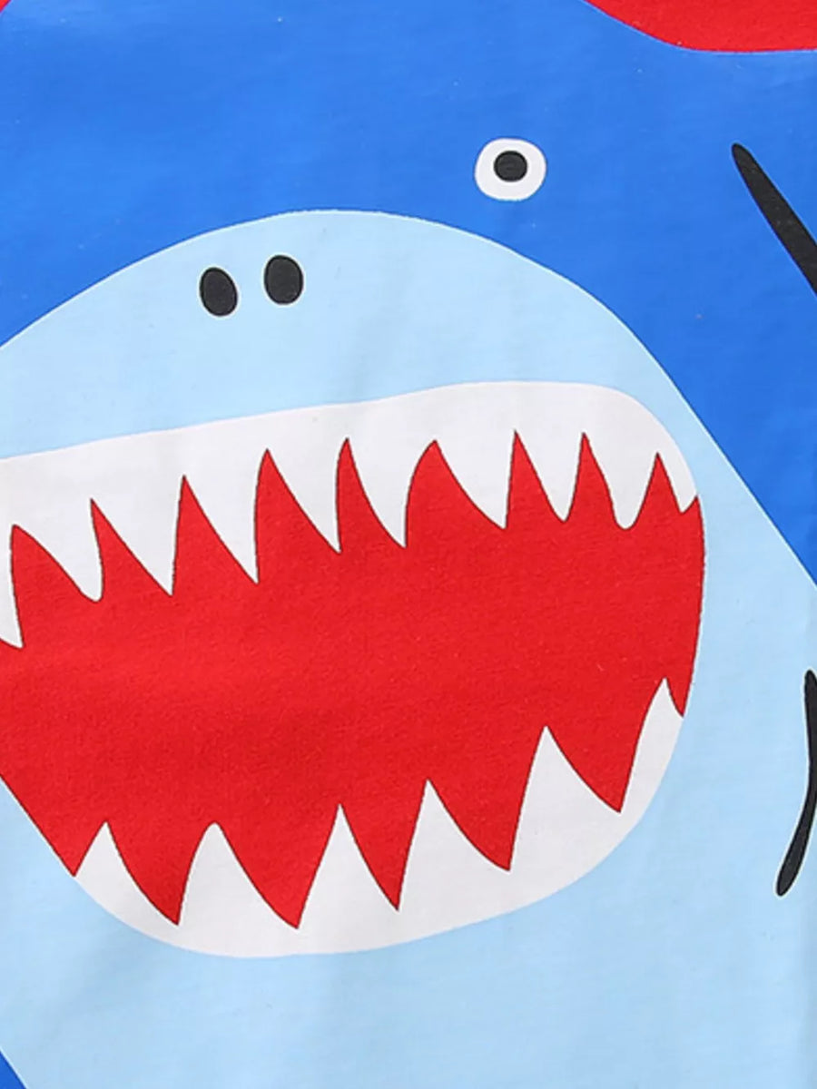 Toddler blue cotton t-shirt with a playful shark graphic and sharp teeth.