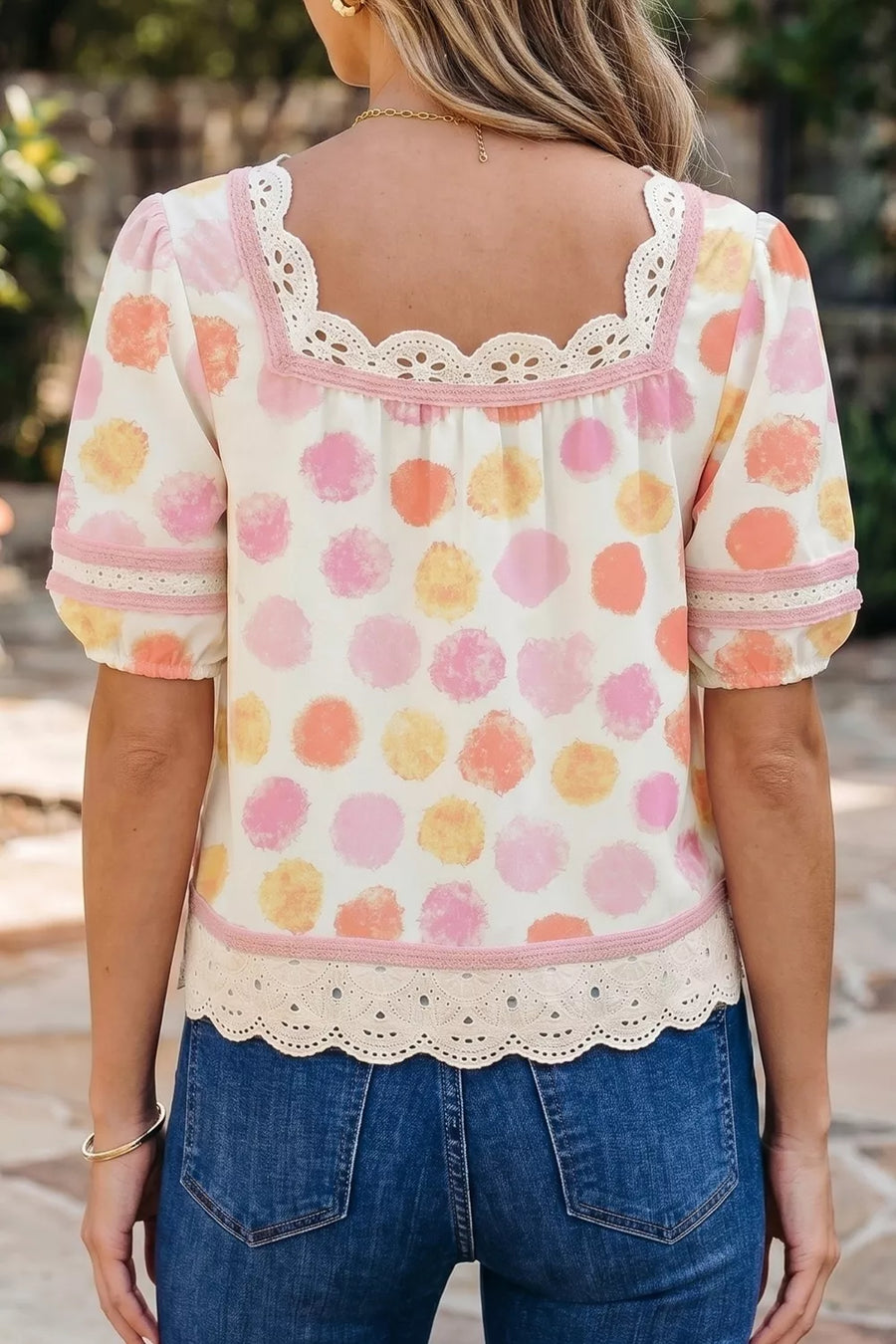 Whimsical polka dot blouse with puff sleeves, lace trim, and a square neckline.