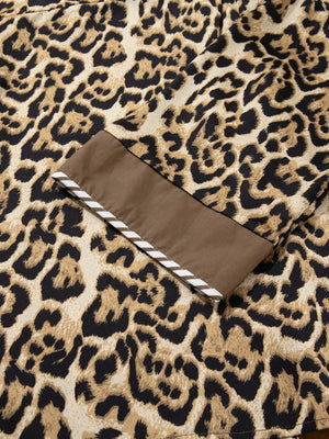 Chic leopard print two-piece set with brown trim and white stripe detail on cuff.