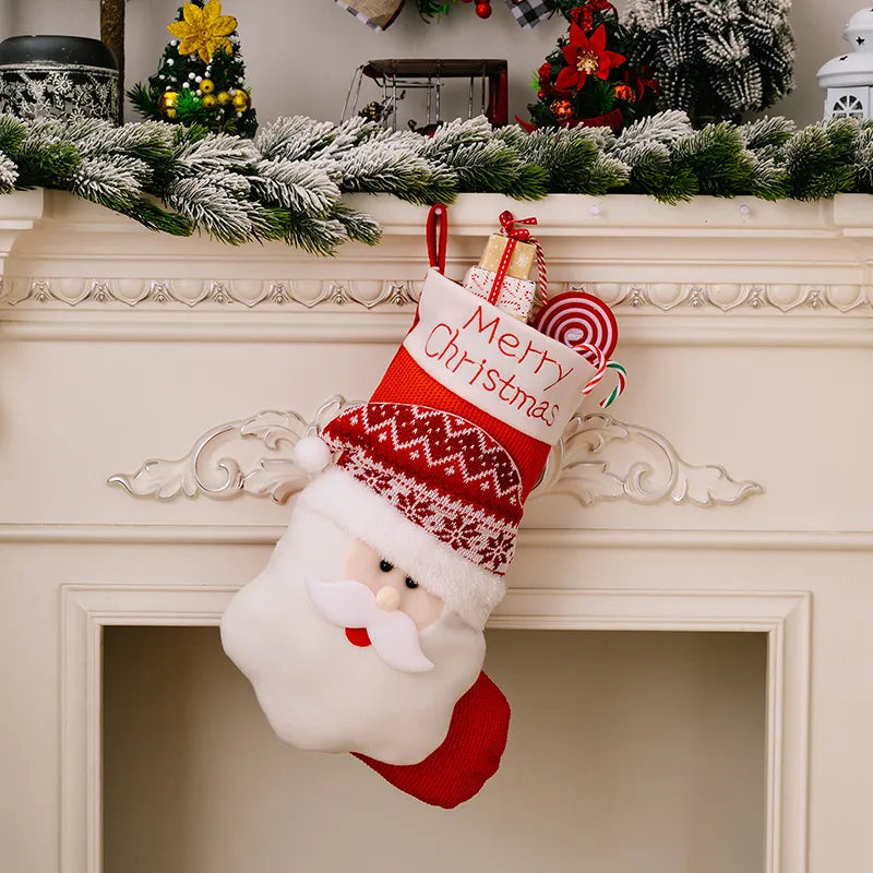 Santa Claus Christmas stocking with Merry Christmas text and holiday treats spilling out.