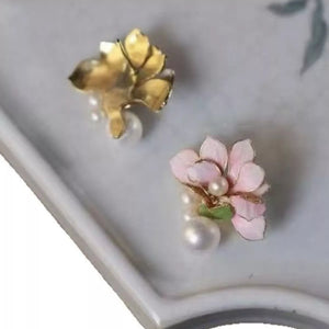Floral pearl stud earrings in blush pink with gold accents and pearl drops.