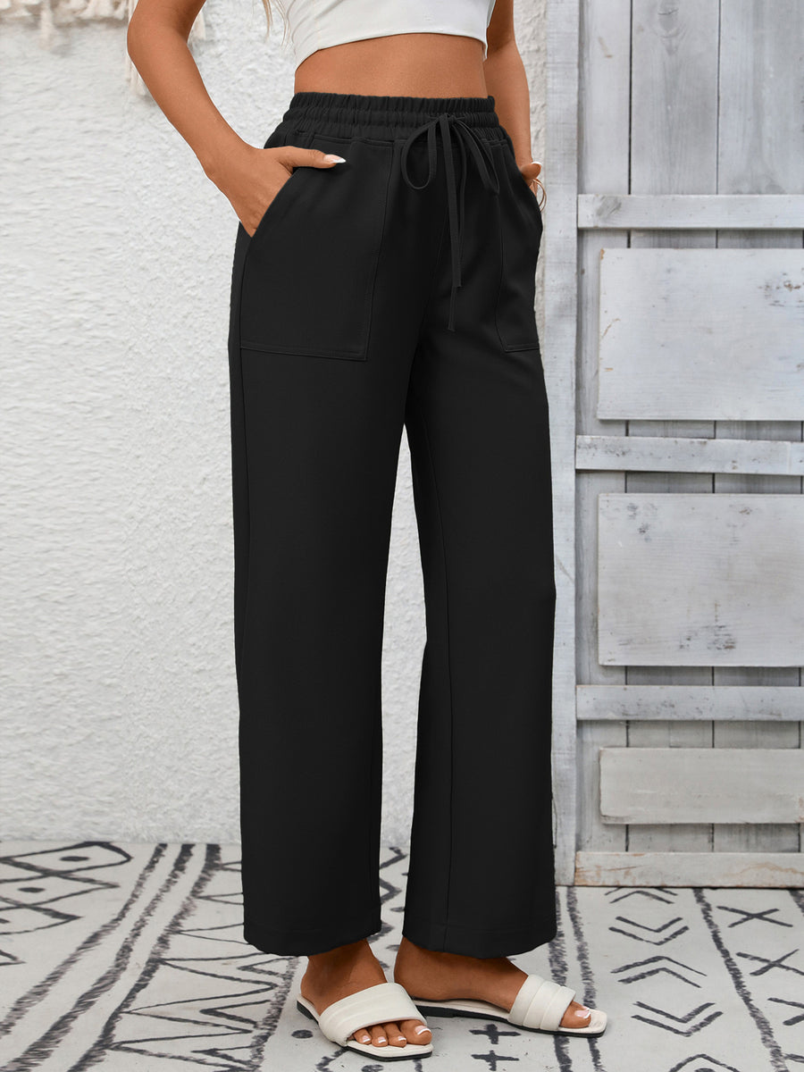Black relaxed drawstring wide-leg pants with pockets and elastic waistband.