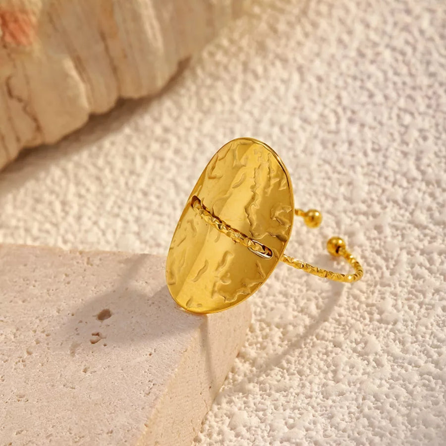 Gold ring featuring hammered texture and hammered texture