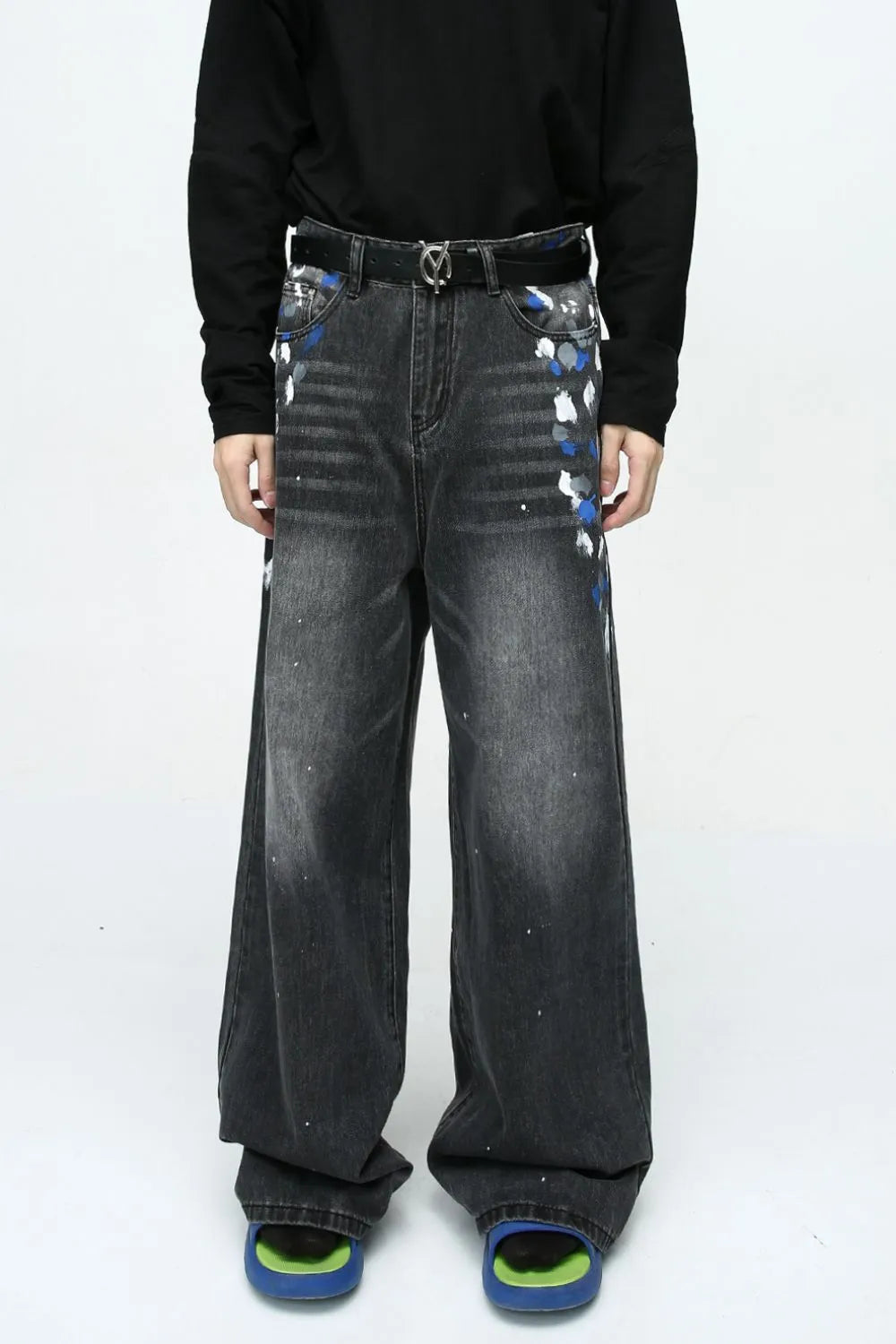 Dark wash wide leg jeans with artistic brushstroke paint splatters and a distressed finish.