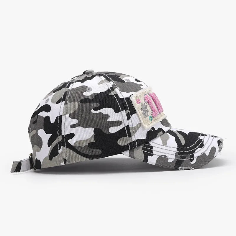 Camouflage patch baseball cap with embroidered detail in black and white camo.