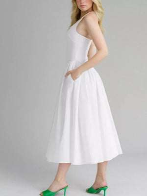 White halter neck midi dress with pockets and a full skirt.