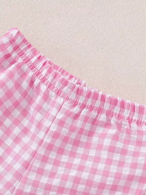 Pink gingham cotton baby shorts with elastic waistband and ruffled detail.