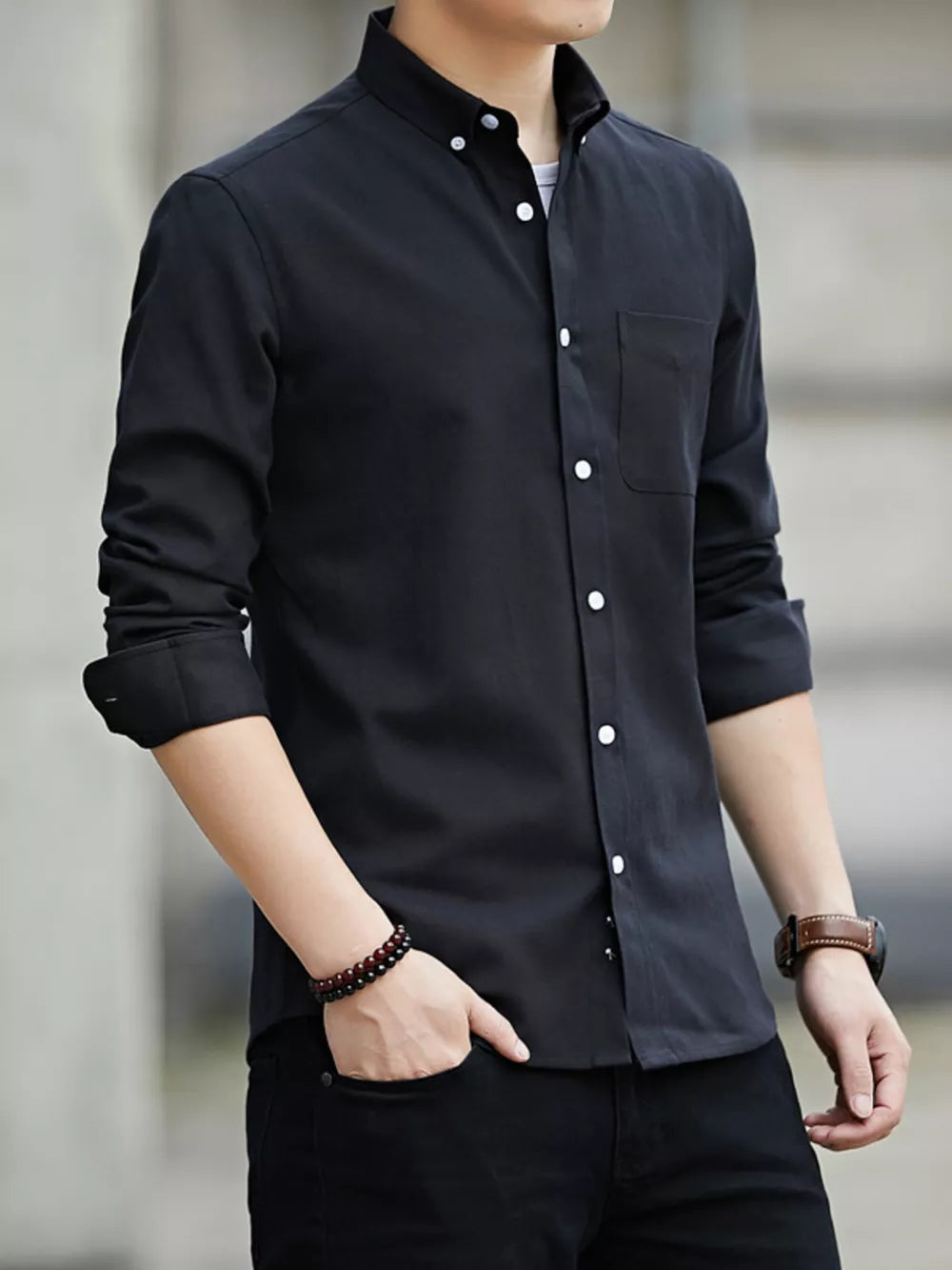 Black cotton button-down casual shirt with chest pocket and white buttons.