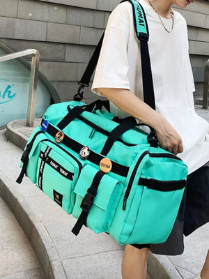 Green duffel bag with multiple pockets and black straps, worn by a person.