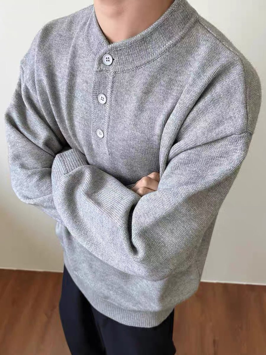 Grey knit sweater with button placket and long sleeves