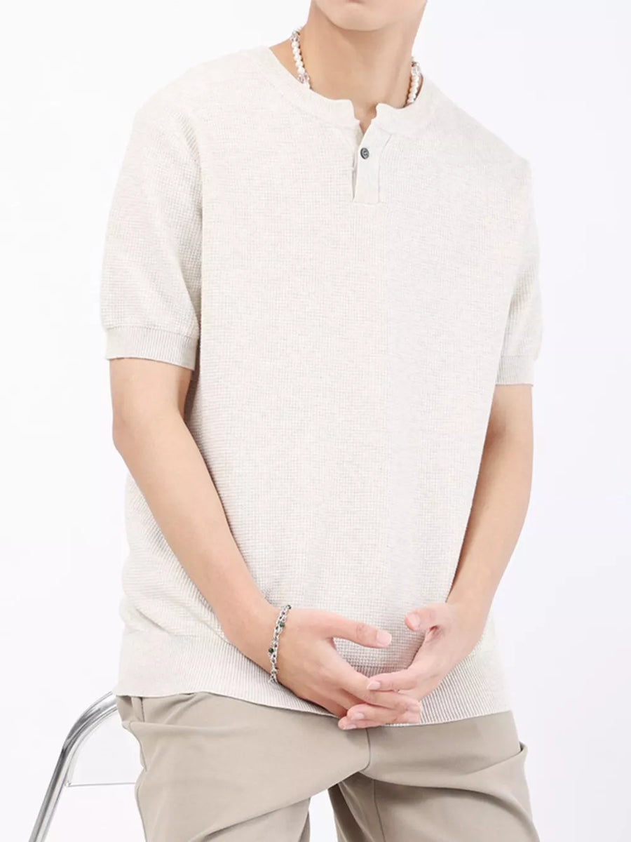 Men's casual knitted henley shirt in a light neutral color with short sleeves and a two-button placket.