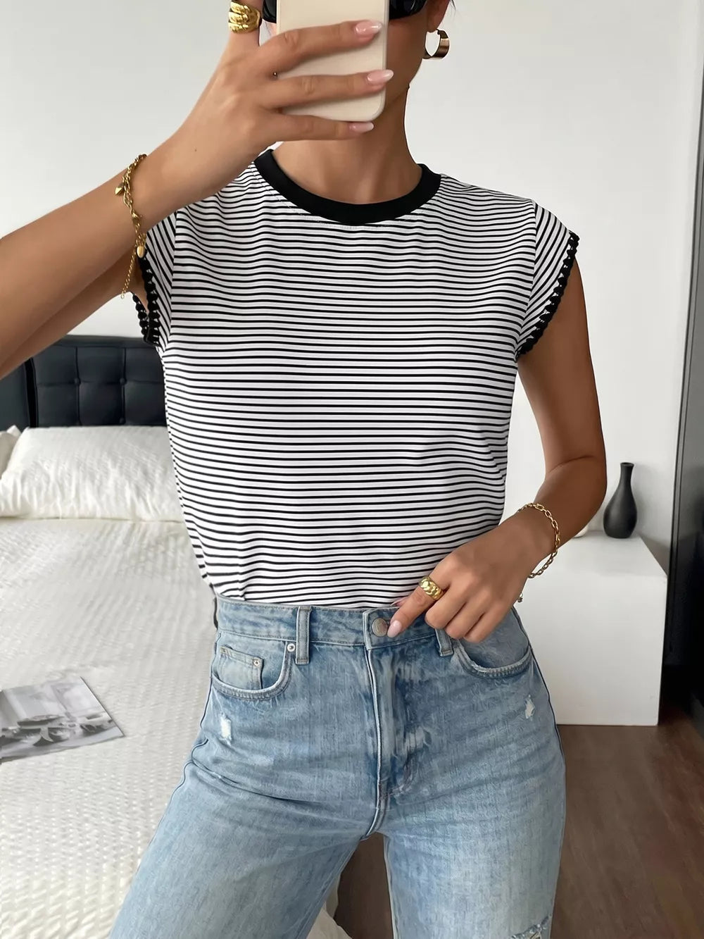 Black and white striped crew neck tee with black trim on sleeves and neckline.