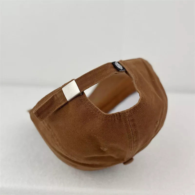 Brown baseball cap with adjustable strap and silver buckle detail.