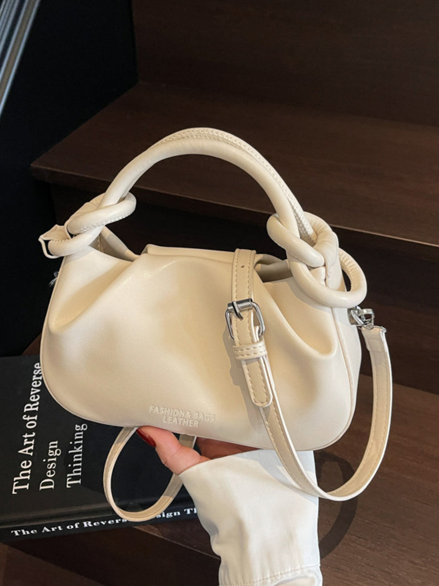 Off-white ruched crossbody bag with knot handle and adjustable strap