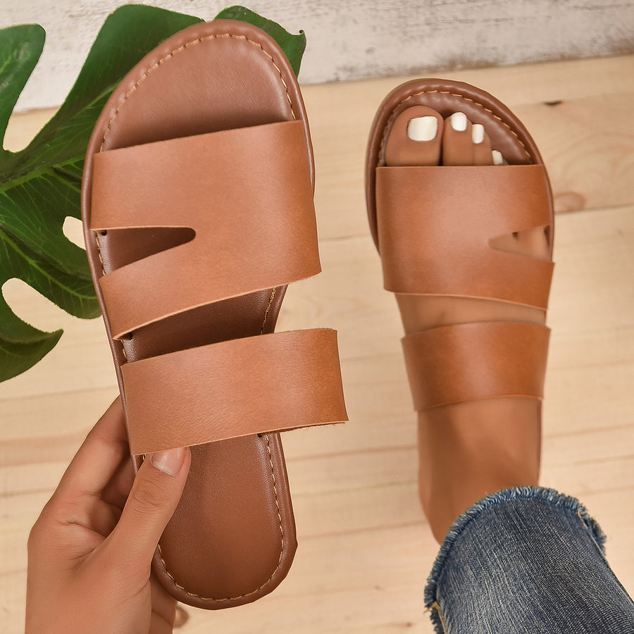 Chic open toe flat sandals in dark brown with double strap detail.