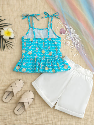 Blue seahorse print cami with tie straps and peplum hem, paired with white shorts.
