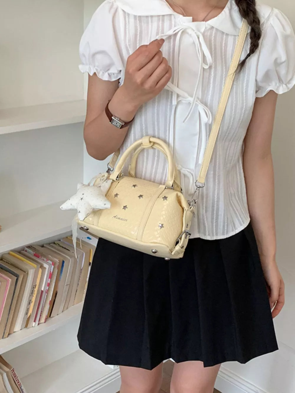 Yellow crossbody bag featuring star embellishments and star