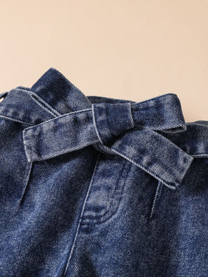 Acid-wash denim jeans with a tie waist detail.
