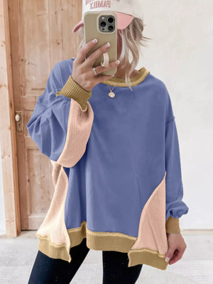 Dusty blue tunic with waffle-knit contrast panels and tan trim.