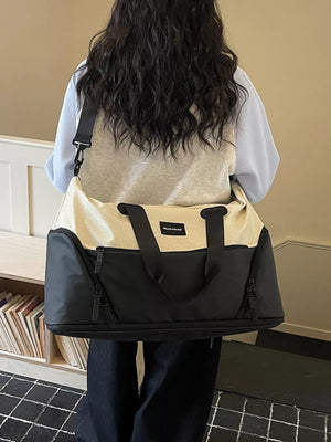 Textured two-tone large duffle bag in black and cream with adjustable strap