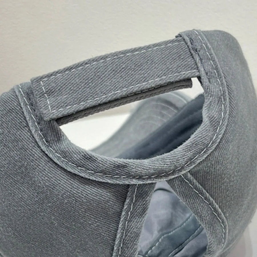 Gray baseball cap with adjustable strap detail and white contrast stitching