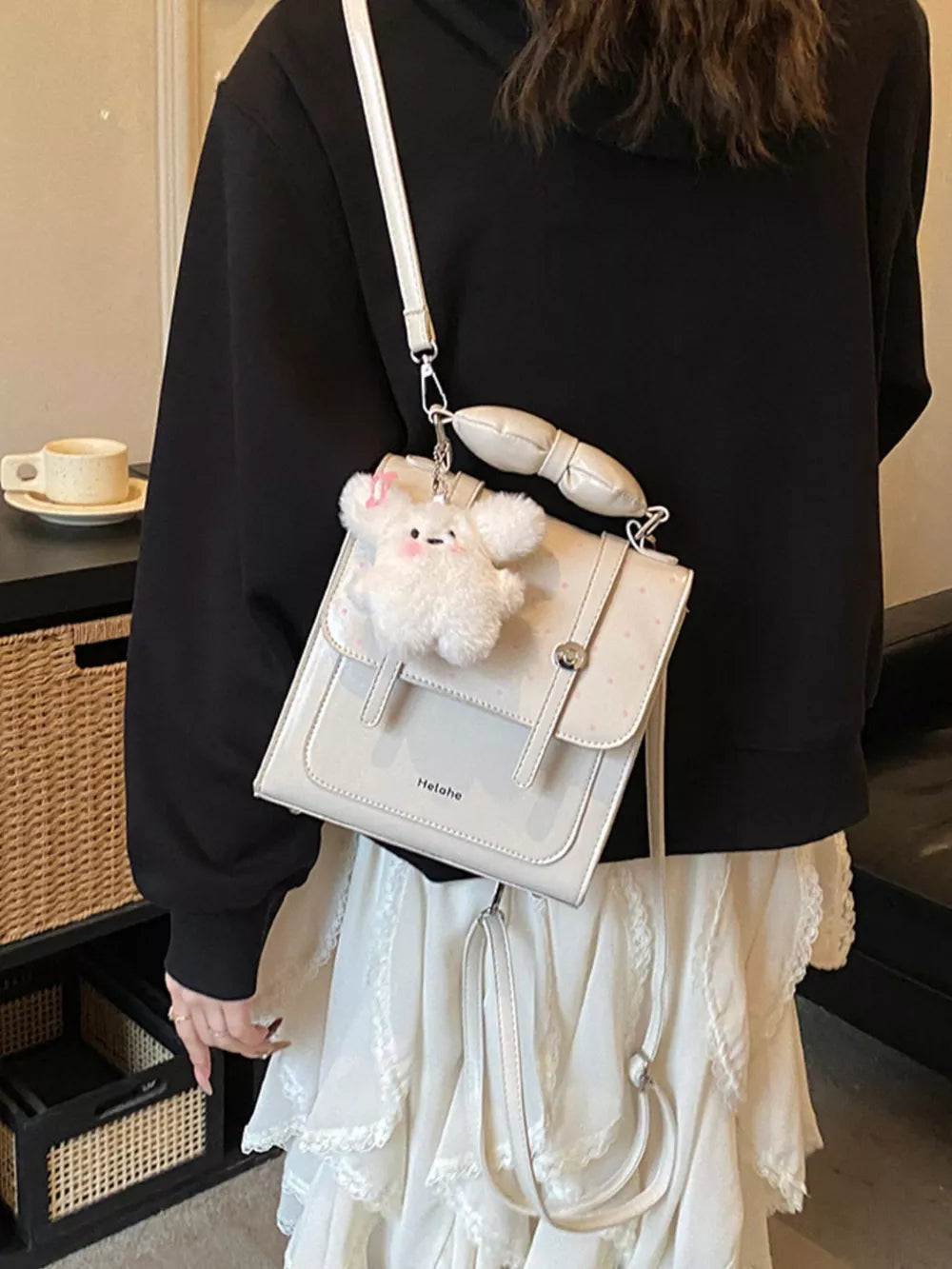 backpack in ivory featuring flap closure and boxy fit