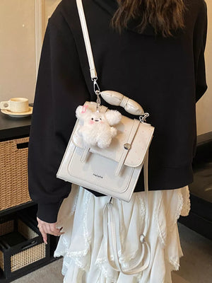 backpack in ivory featuring flap closure and boxy fit