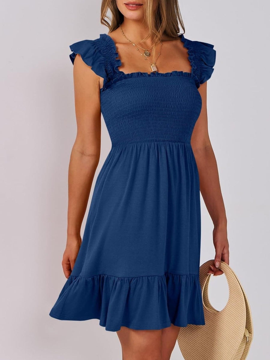 Navy smocked ruffle hem mini dress with square neckline and flutter sleeves.