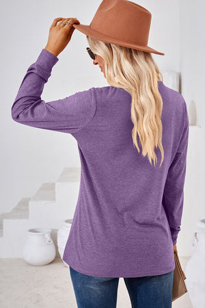 Henley button-down knit top in lavender with long sleeves and a relaxed fit.