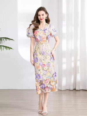 Sheath dress with colorful floral embroidery, V-neck, puff sleeves, and midi length.