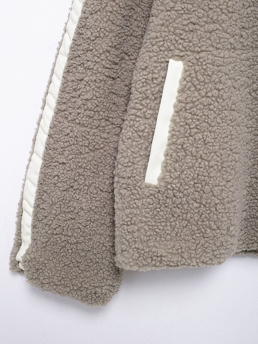 Dust Storm teddy fleece zip-up jacket with white contrast piping and pocket detail.