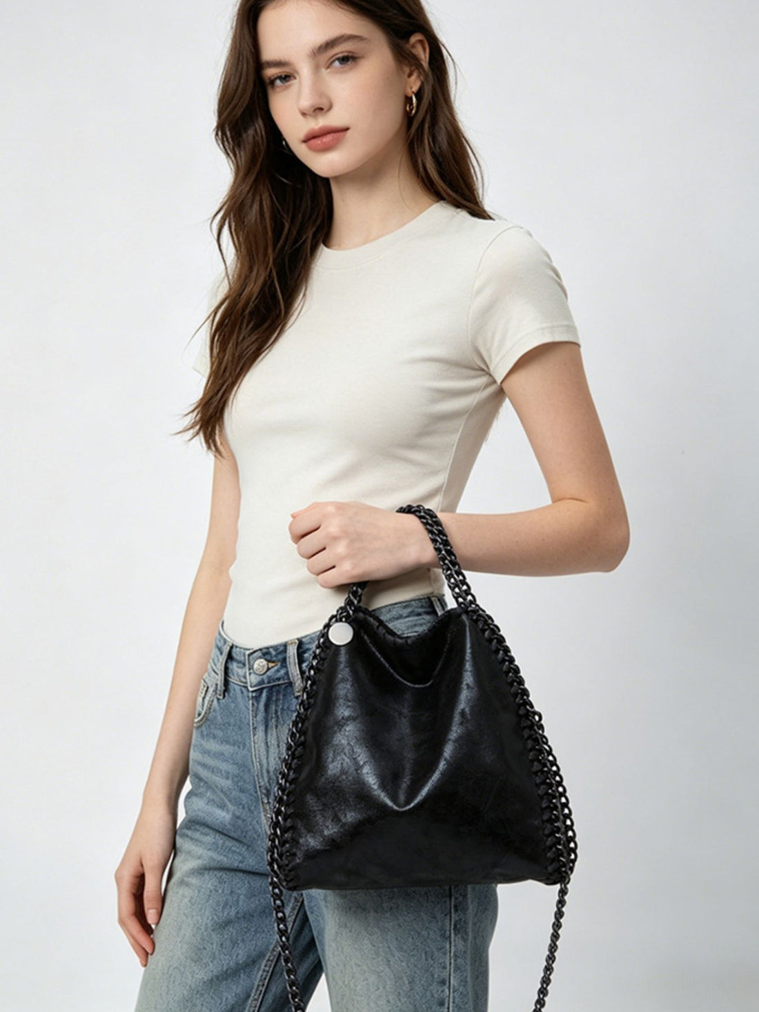 crossbody bag in black featuring chain strap and slouchy fit