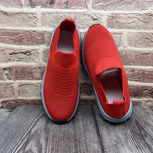 Red breathable round toe slip-on sneakers with a knit upper and grey sole.