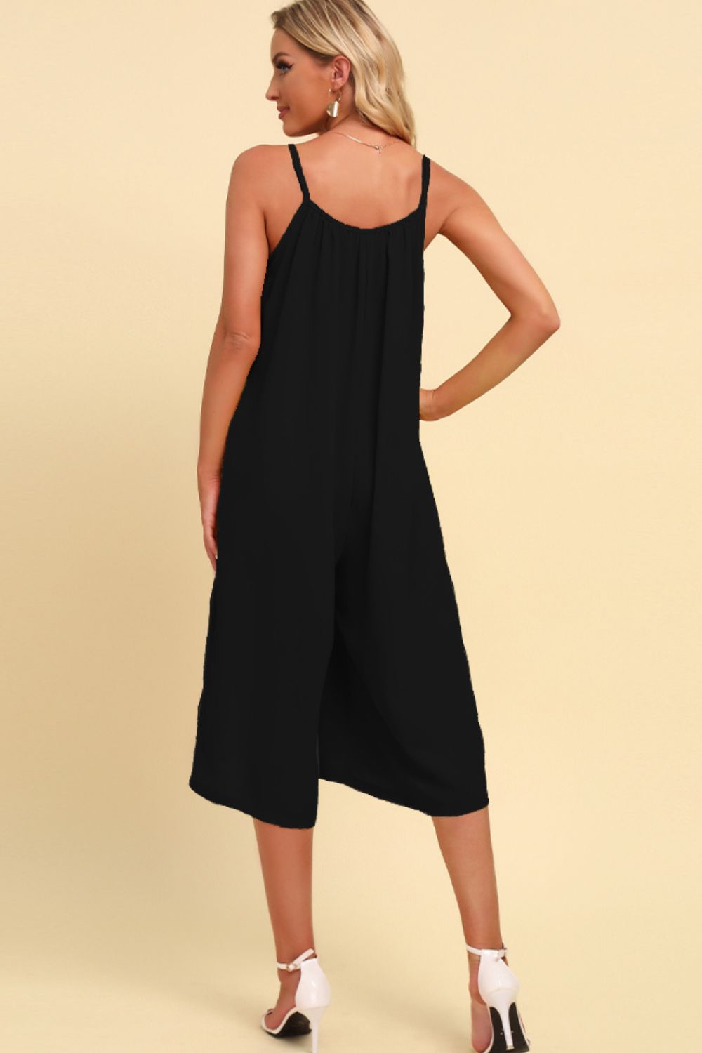 Black culotte jumpsuit with gathered bodice and spaghetti straps.